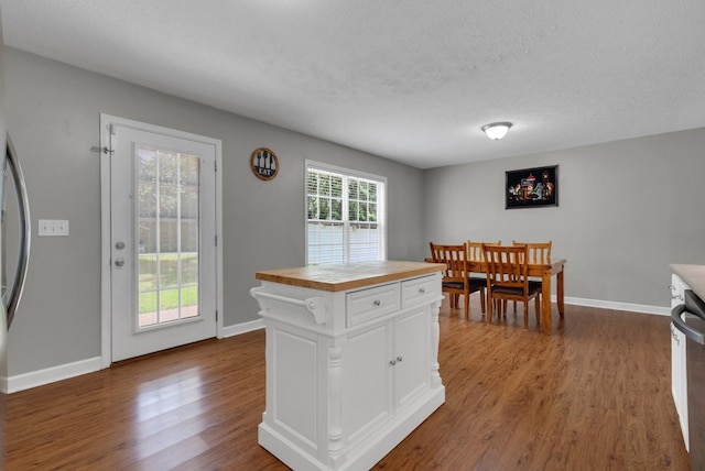 939 Wing Tip Cir, Hopkinsville, KY 42240 - kitchen with wood counters, dark wood-type flooring, white cabinetry, a textured ceiling, and a kitchen island