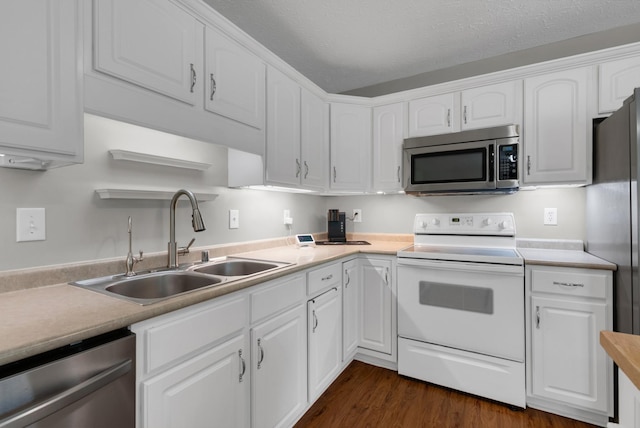 939 Wing Tip Cir, Hopkinsville, KY 42240 - kitchen with stainless steel appliances, white cabinetry, light countertops, and dark wood finished floors