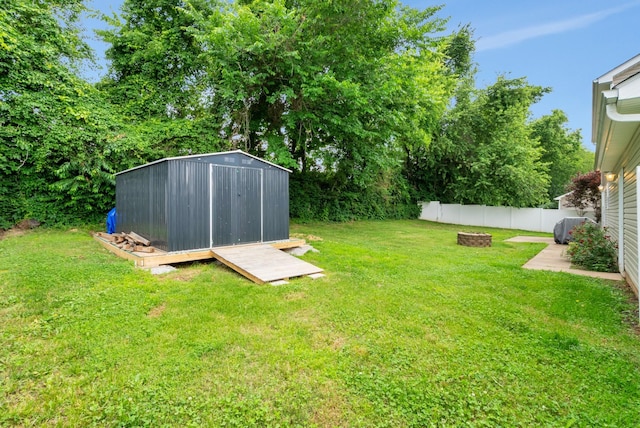 939 Wing Tip Cir, Hopkinsville, KY 42240 - fenced backyard with a fire pit and a storage unit