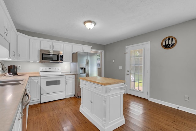 939 Wing Tip Cir, Hopkinsville, KY 42240 - kitchen featuring appliances with stainless steel finishes, white cabinets, light wood-style floors, and a textured ceiling