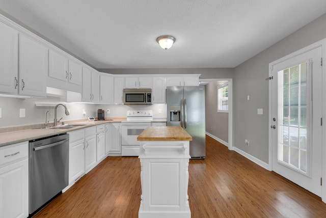 939 Wing Tip Cir, Hopkinsville, KY 42240 - kitchen featuring stainless steel appliances, wooden counters, white cabinets, a kitchen island, and wood finished floors
