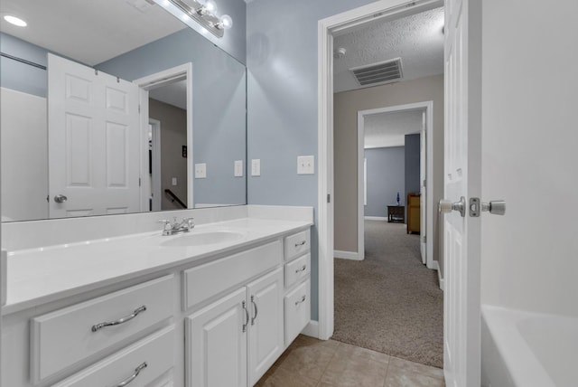 939 Wing Tip Cir, Hopkinsville, KY 42240 - full bathroom with vanity, a tub, a textured ceiling, and tile patterned floors