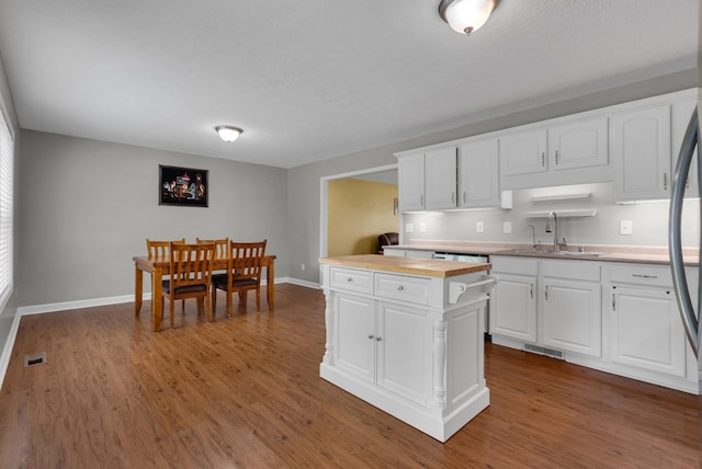 939 Wing Tip Cir, Hopkinsville, KY 42240 - kitchen with white cabinets, wooden counters, and dark wood-style floors