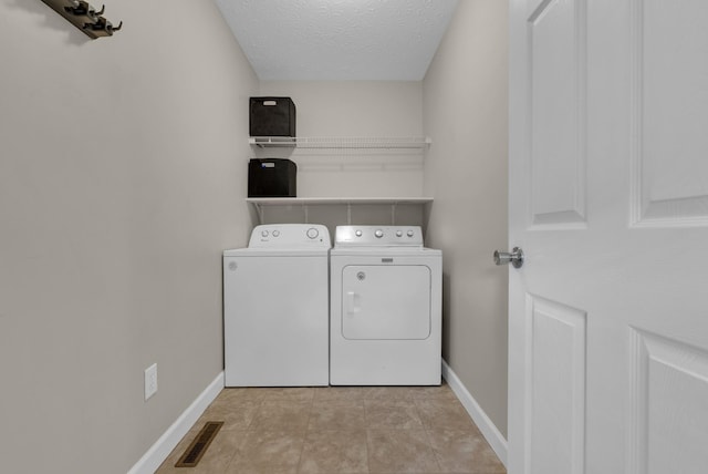 939 Wing Tip Cir, Hopkinsville, KY 42240 - laundry room with separate washer and dryer, a textured ceiling, and light tile patterned flooring