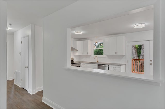 4921 Shihmen Dr, Antioch, TN 37013 - kitchen with stainless steel appliances, light countertops, dark wood-style flooring, white cabinets, and backsplash
