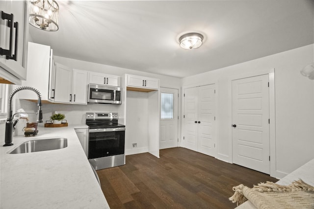 5670 Lakeview Rd, Springfield, TN 37172 - kitchen with appliances with stainless steel finishes, light countertops, white cabinetry, and dark wood-style flooring