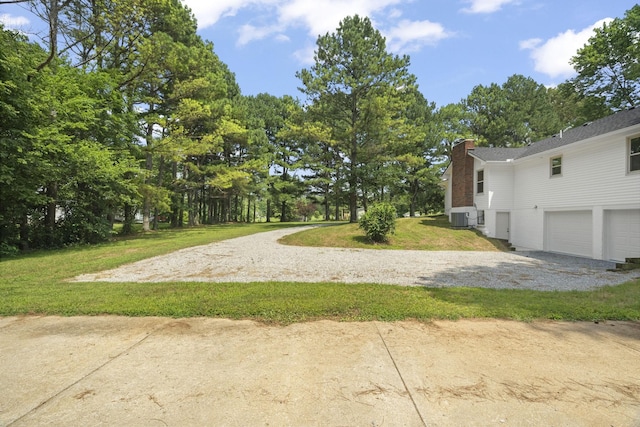 5670 Lakeview Rd, Springfield, TN 37172 - view of grassy yard featuring gravel driveway, an attached garage, and view of wooded area