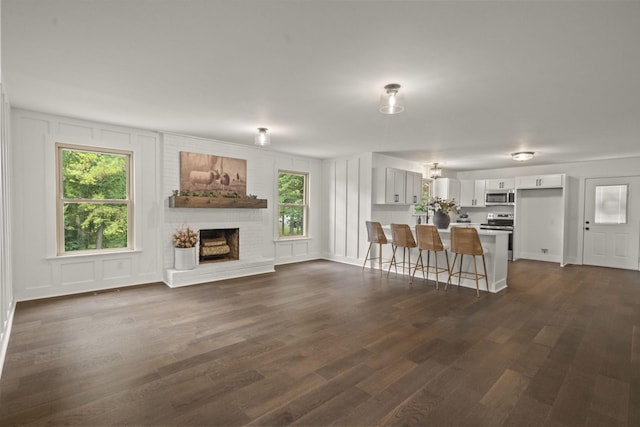 5670 Lakeview Rd, Springfield, TN 37172 - living area with a brick fireplace and dark wood-style flooring