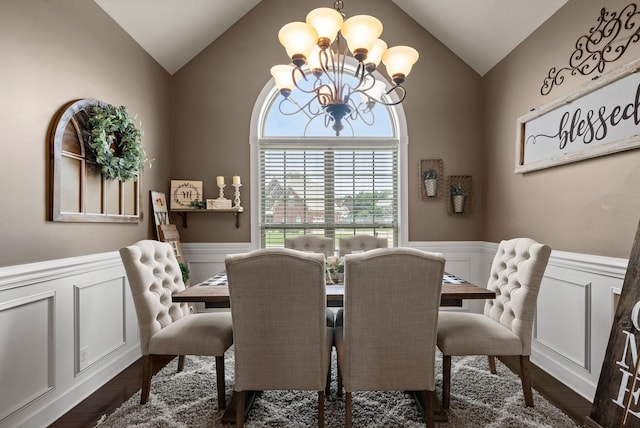 1192 Wicke Rd, Adams, TN 37010 - dining room featuring vaulted ceiling, a chandelier, wainscoting, dark wood-style flooring, and a decorative wall