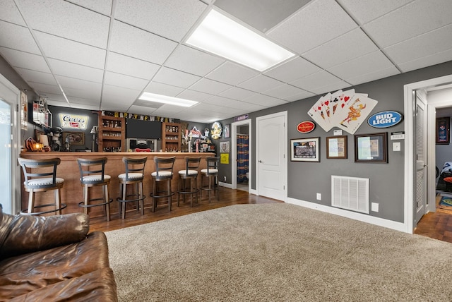 1192 Wicke Rd, Adams, TN 37010 - indoor dry bar featuring a drop ceiling, carpet floors, and wood finished floors