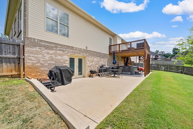 1192 Wicke Rd, Adams, TN 37010 - back of house featuring a hot tub, french doors, brick siding, a fenced backyard, and a patio area
