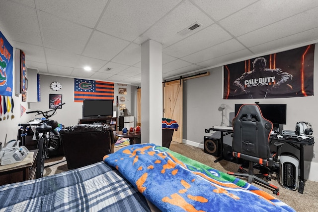 1192 Wicke Rd, Adams, TN 37010 - bedroom with a barn door, a paneled ceiling, and carpet flooring