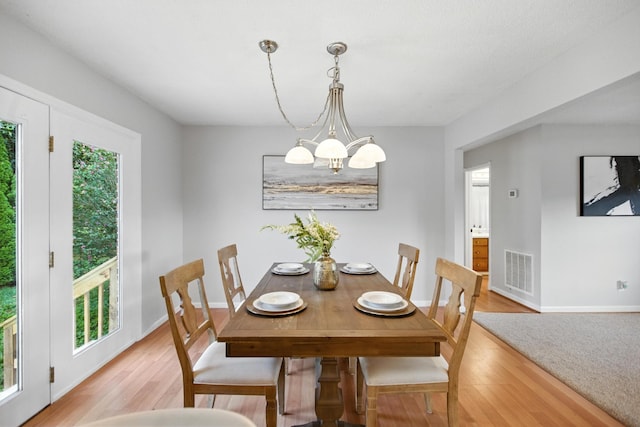 215 Patrick St, Estill Springs, TN 37330 - dining space with light wood-style flooring and a chandelier
