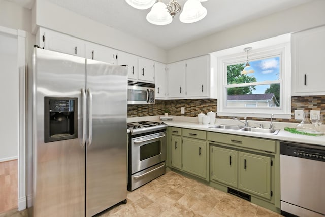 215 Patrick St, Estill Springs, TN 37330 - kitchen featuring appliances with stainless steel finishes, green cabinetry, a chandelier, decorative backsplash, and light countertops