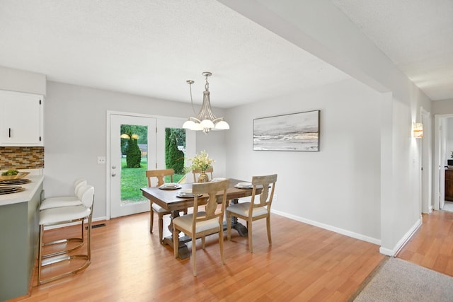 215 Patrick St, Estill Springs, TN 37330 - dining space with light wood-type flooring and a chandelier
