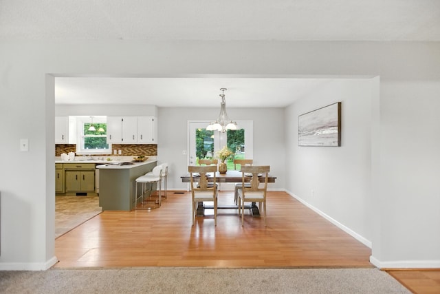 215 Patrick St, Estill Springs, TN 37330 - dining space with light wood-type flooring and a chandelier