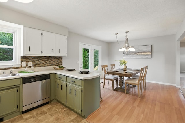 215 Patrick St, Estill Springs, TN 37330 - kitchen with stainless steel dishwasher, green cabinetry, a peninsula, and light countertops