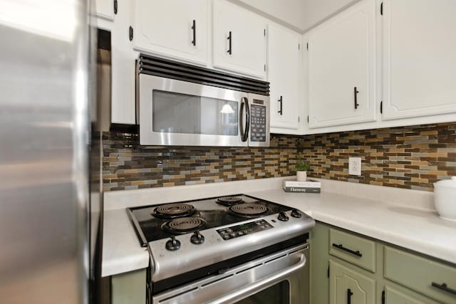 215 Patrick St, Estill Springs, TN 37330 - kitchen with appliances with stainless steel finishes, green cabinets, light countertops, and tasteful backsplash