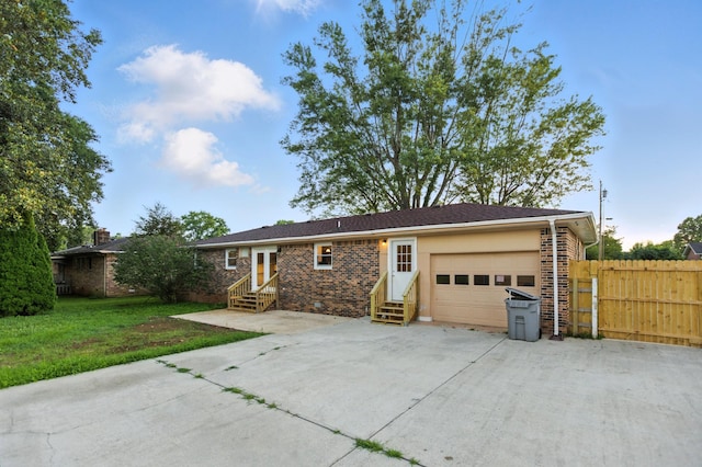 215 Patrick St, Estill Springs, TN 37330 - view of front of property featuring entry steps, an attached garage, concrete driveway, and brick siding