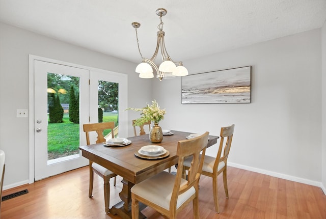 215 Patrick St, Estill Springs, TN 37330 - dining room with light wood-type flooring and a chandelier