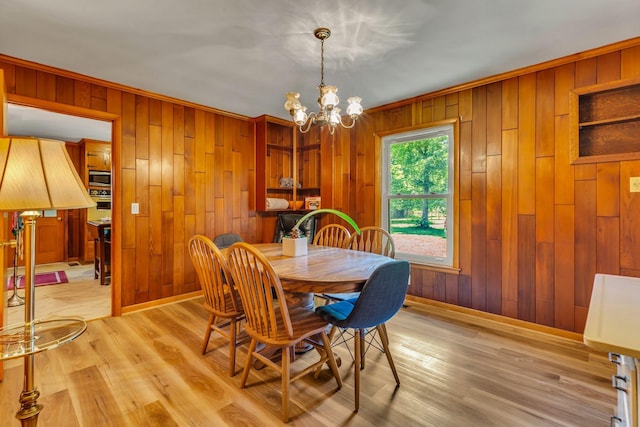 1011 S Baird Ln, Murfreesboro, TN 37130 - dining space featuring a chandelier, wood walls, and light wood-style flooring