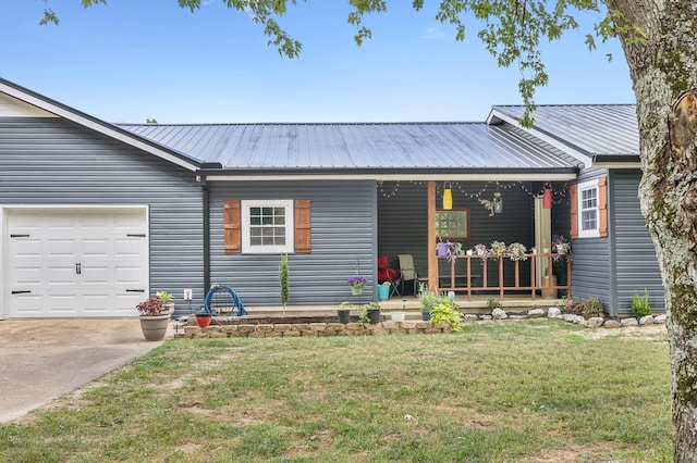 140 Cane Creek Rd, Hohenwald, TN 38462 - single story home with a porch, a front yard, a metal roof, concrete driveway, and a garage