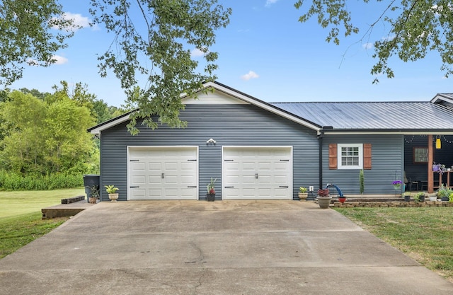 140 Cane Creek Rd, Hohenwald, TN 38462 - view of front of home with a front lawn, driveway, a metal roof, and a garage