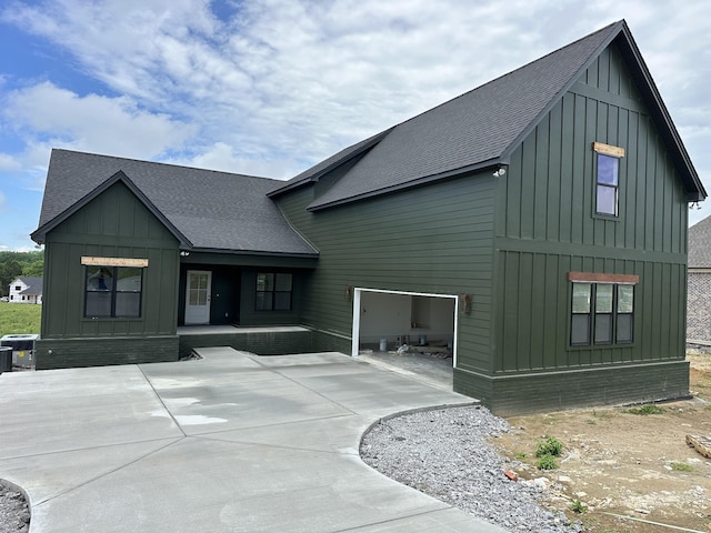 115 Crenshaw Rd, Hartsville, TN 37074 - rear view of house with a shingled roof, board and batten siding, covered porch, and driveway