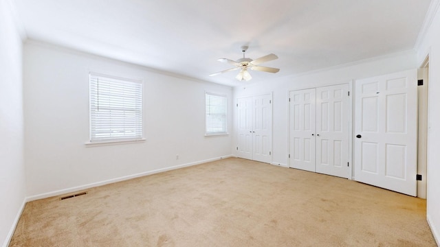 1002 E Northfield Blvd Unit G105, Murfreesboro, TN 37130 - unfurnished bedroom featuring multiple closets, carpet, crown molding, and a ceiling fan