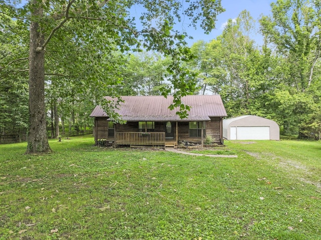 2200 Rawls Rd, Greenbrier, TN 37073 - view of front of home featuring covered porch, a front yard, an outbuilding, a garage, and a metal roof