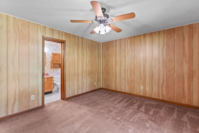 2200 Rawls Rd, Greenbrier, TN 37073 - spare room with carpet, a textured ceiling, ceiling fan, and wooden walls