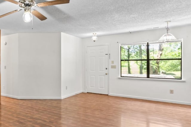 2200 Rawls Rd, Greenbrier, TN 37073 - empty room with wood finished floors, ceiling fan, and a textured ceiling