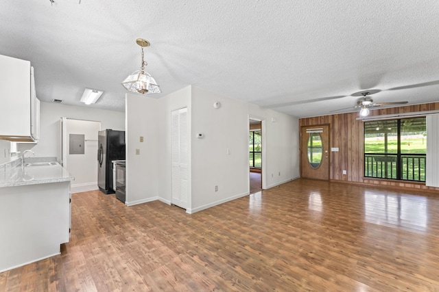 2200 Rawls Rd, Greenbrier, TN 37073 - unfurnished living room featuring wood finished floors, a textured ceiling, and a ceiling fan