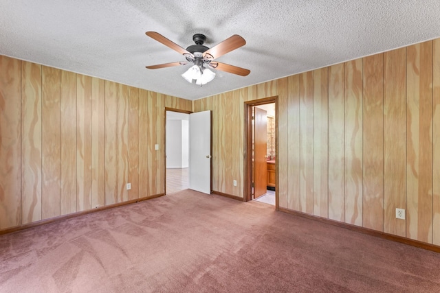 2200 Rawls Rd, Greenbrier, TN 37073 - carpeted spare room featuring a ceiling fan, a textured ceiling, and wood walls
