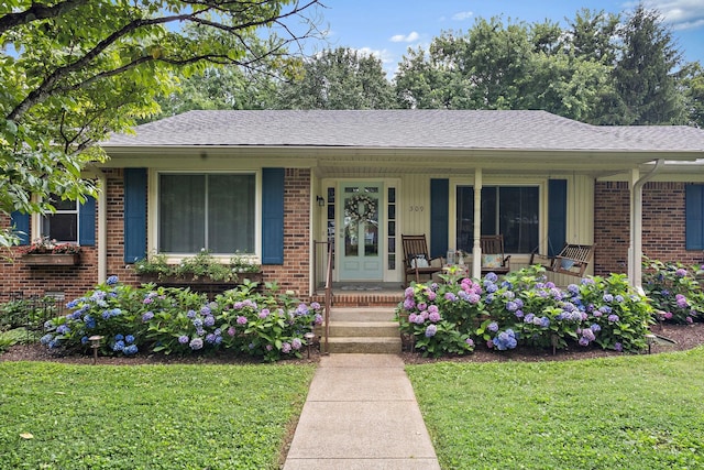 509 Iris Ave, Murfreesboro, TN 37128 - ranch-style house featuring covered porch, a front lawn, brick siding, and roof with shingles