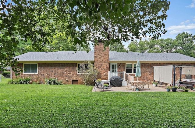 509 Iris Ave, Murfreesboro, TN 37128 - back of property with a patio area, a chimney, brick siding, and a lawn