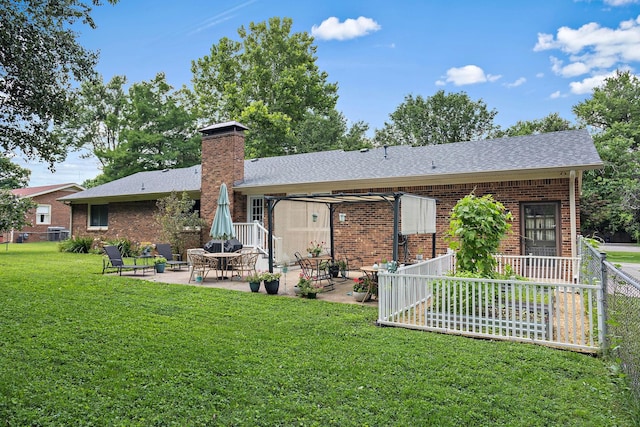 509 Iris Ave, Murfreesboro, TN 37128 - back of property with brick siding, a patio area, a chimney, and roof with shingles