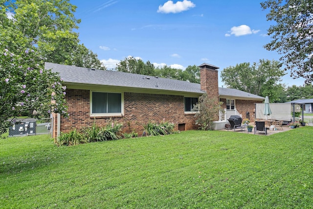 509 Iris Ave, Murfreesboro, TN 37128 - back of house featuring a patio area, brick siding, a chimney, and roof with shingles