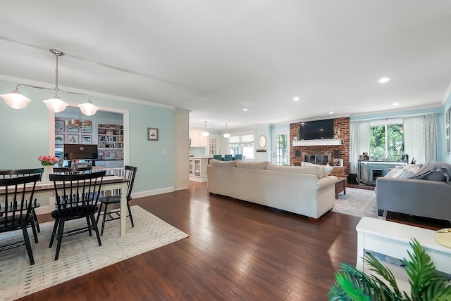 509 Iris Ave, Murfreesboro, TN 37128 - living room with crown molding, dark wood finished floors, a brick fireplace, and recessed lighting