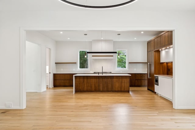 4045 Outer Dr, Nashville, TN 37204 - kitchen featuring modern cabinets, light wood finished floors, backsplash, light countertops, and recessed lighting