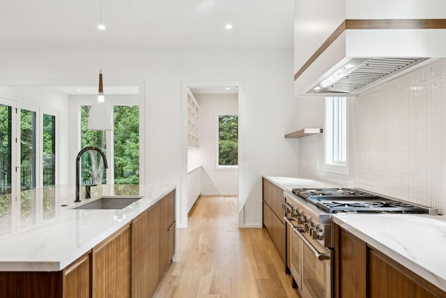 4045 Outer Dr, Nashville, TN 37204 - kitchen featuring high end stainless steel range, premium range hood, light wood-style flooring, brown cabinetry, and recessed lighting