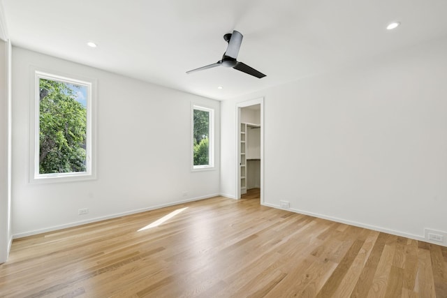 4045 Outer Dr, Nashville, TN 37204 - unfurnished bedroom featuring multiple windows, light wood finished floors, a walk in closet, recessed lighting, and a ceiling fan