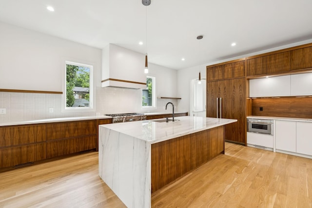 4045 Outer Dr, Nashville, TN 37204 - kitchen featuring custom exhaust hood, modern cabinets, light wood-style floors, and recessed lighting