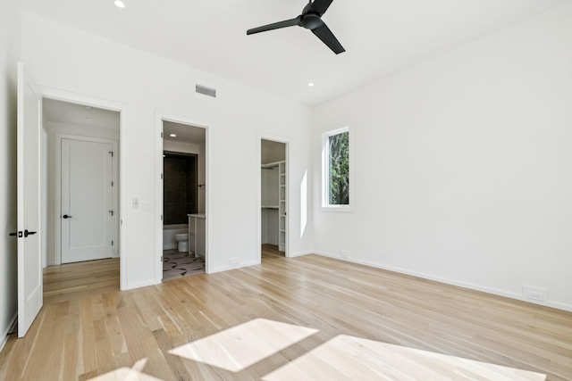 4045 Outer Dr, Nashville, TN 37204 - unfurnished bedroom featuring a walk in closet, light wood-type flooring, ensuite bathroom, a closet, and recessed lighting