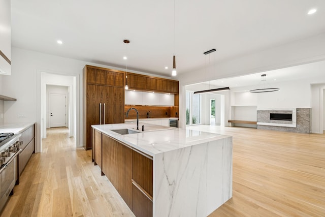 4045 Outer Dr, Nashville, TN 37204 - kitchen featuring modern cabinets, light wood-style floors, recessed lighting, brown cabinetry, and a spacious island