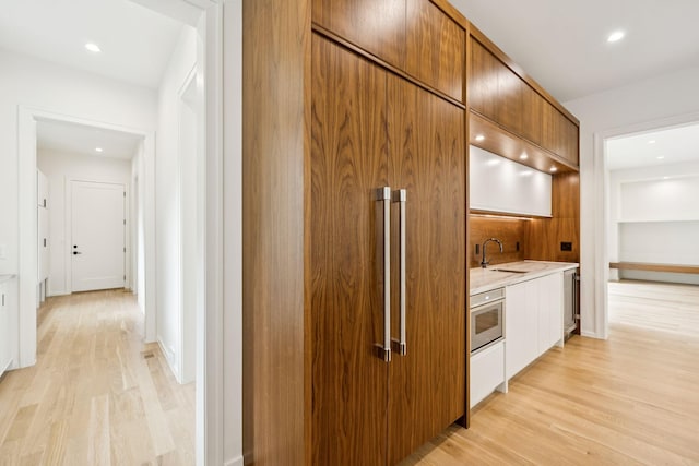 4045 Outer Dr, Nashville, TN 37204 - kitchen featuring light wood-style floors, light countertops, modern cabinets, brown cabinetry, and recessed lighting