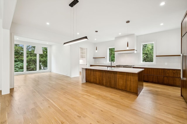 4045 Outer Dr, Nashville, TN 37204 - kitchen featuring modern cabinets, light countertops, light wood finished floors, decorative backsplash, and recessed lighting