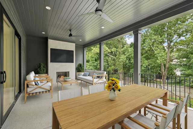 4045 Outer Dr, Nashville, TN 37204 - view of patio featuring an outdoor living space with a fireplace, a ceiling fan, view of wooded area, and outdoor dining space