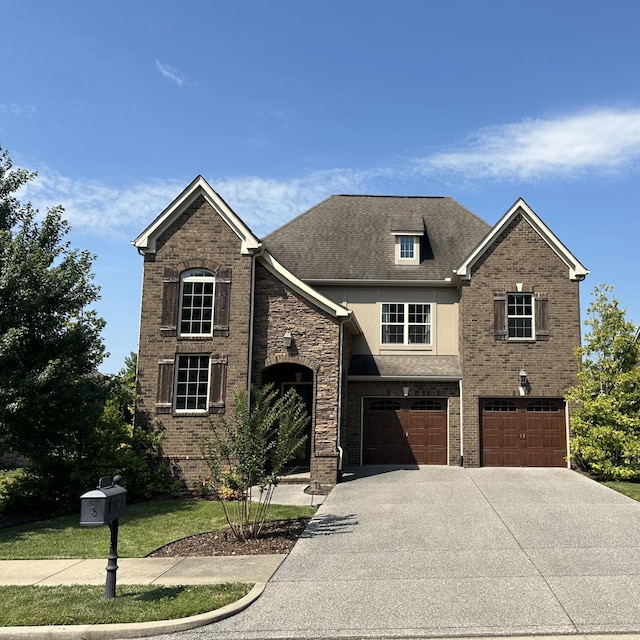 1039 Baxter Ln, Gallatin, TN 37066 - view of front of house with driveway, a garage, brick siding, and roof with shingles
