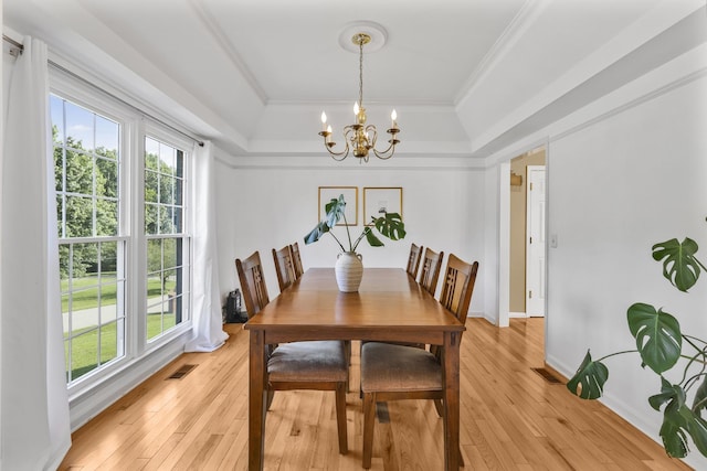 1903 Palmer Dr, Springfield, TN 37172 - dining room featuring a tray ceiling, a chandelier, light wood-style floors, and ornamental molding